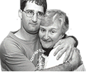 photo of an elderly woman hugging a young man